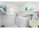 Functional laundry room with washer, dryer, sink, and ample storage space at 20 Bunker Way, Rotonda West, FL 33947