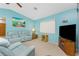 Bright and cozy living room with comfortable blue furnishings and a ceiling fan at 20 Bunker Way, Rotonda West, FL 33947