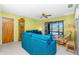 Cozy living room with plush sofas, ceiling fan, and sliding glass doors leading to the pool area at 20 Bunker Way, Rotonda West, FL 33947