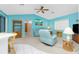 Cozy living room with blue walls, comfortable seating, and a ceiling fan at 20 Bunker Way, Rotonda West, FL 33947