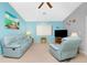 Bright and cozy living room with comfortable blue furnishings and a ceiling fan at 20 Bunker Way, Rotonda West, FL 33947