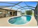 Backyard screened-in pool features a step entry, blue tile, and clear blue water at 20 Bunker Way, Rotonda West, FL 33947