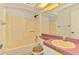 Bathroom featuring a bath, toilet, vanity with countertop space and mirror, offering essential amenities at 200 Rotonda W Blvd # A2, Rotonda West, FL 33947