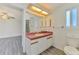 Bathroom with a spacious vanity area, a toilet, and a shower, blending comfort and functionality at 200 Rotonda W Blvd # A2, Rotonda West, FL 33947