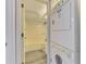 Bathroom and laundry area with stacked washer and dryer next to a full bath, perfect for convenience at 200 Rotonda W Blvd # A2, Rotonda West, FL 33947