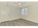 Well-lit bedroom featuring wood-look floors, ceiling fan, and sheer curtains at 200 Rotonda W Blvd # A2, Rotonda West, FL 33947