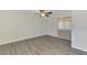 Bedroom with wood-look floors, neutral walls, and natural light from window at 200 Rotonda W Blvd # A2, Rotonda West, FL 33947