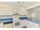 Bright kitchen with white cabinetry, wood-look floors, and standard appliances at 200 Rotonda W Blvd # A2, Rotonda West, FL 33947
