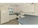 Classic kitchen with white appliances, white cabinets and updated flooring at 200 Rotonda W Blvd # A2, Rotonda West, FL 33947