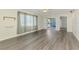 Bright living room featuring gray laminate floors and access to the screen-in balcony at 200 Rotonda W Blvd # A2, Rotonda West, FL 33947