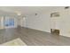 Open living room layout with light gray laminate floors and bright, neutral paint at 200 Rotonda W Blvd # A2, Rotonda West, FL 33947