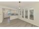 Open-concept living area showcasing the kitchen, new floors, and natural light at 200 Rotonda W Blvd # A2, Rotonda West, FL 33947
