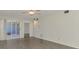 Large living room boasts new flooring and natural light, with a slider to the screened-in patio at 200 Rotonda W Blvd # A2, Rotonda West, FL 33947