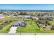 Expansive aerial view of a home with a large yard, three car garage and a swimming pool at 213 Sunset Rd, Rotonda West, FL 33947