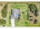 An aerial view of a single-Gathering home with a large backyard and pool at 213 Sunset Rd, Rotonda West, FL 33947
