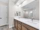Modern bathroom with double sinks, a large mirror, and wood cabinets at 213 Sunset Rd, Rotonda West, FL 33947