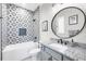 Charming bathroom features decorative tile, a bathtub, and a granite sink at 213 Sunset Rd, Rotonda West, FL 33947