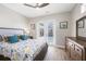 Comfortable bedroom with a ceiling fan and french door access to the pool at 213 Sunset Rd, Rotonda West, FL 33947