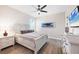 Bright bedroom features a ceiling fan, light wood-look floors and coastal decor at 213 Sunset Rd, Rotonda West, FL 33947