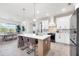 Bright kitchen with an island, stainless steel appliances, and open dining area at 213 Sunset Rd, Rotonda West, FL 33947