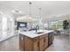 Spacious kitchen with island, pendant lighting, and an open layout leading to dining and living areas at 213 Sunset Rd, Rotonda West, FL 33947