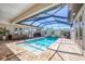 Beautiful screened-in pool area with outdoor kitchen and multiple lounging options at 213 Sunset Rd, Rotonda West, FL 33947