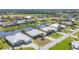 An aerial view of the homes in the neighborhood, showing a pond, golf course and beautiful landscaping at 25 Medalist Ter, Rotonda West, FL 33947