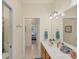 Well-lit bathroom featuring double sinks, granite countertops, and neutral tile flooring at 25 Medalist Ter, Rotonda West, FL 33947