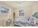 Cozy bedroom with coastal decor, natural light, and a view of the backyard at 25 Medalist Ter, Rotonda West, FL 33947