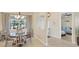 Cozy dining area with natural light, wood table and seating with a view to the front yard at 25 Medalist Ter, Rotonda West, FL 33947