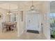 Bright foyer with stylish lighting, tiled flooring, and access to the dining area at 25 Medalist Ter, Rotonda West, FL 33947