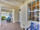 Inviting covered front porch with brick flooring and cozy seating for relaxing outdoors at 25 Medalist Ter, Rotonda West, FL 33947