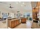 Open kitchen shows breakfast bar, wooden cabinetry, granite countertops, and backyard views at 25 Medalist Ter, Rotonda West, FL 33947