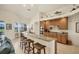 Open kitchen features granite countertops, breakfast bar, stainless appliances, and natural light at 25 Medalist Ter, Rotonda West, FL 33947