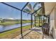 Covered lanai offering tranquil water views, comfortable seating, and outdoor dining space at 25 Medalist Ter, Rotonda West, FL 33947