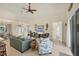 Bright living room boasts a ceiling fan, comfortable seating, and sliding glass doors for natural light at 25 Medalist Ter, Rotonda West, FL 33947