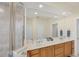 Double sinks, a glass shower, and great lighting can be seen in the main bathroom at 25 Medalist Ter, Rotonda West, FL 33947