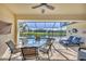 Relaxing screened patio with dining area, lounge chairs, pool, and scenic water view at 25 Medalist Ter, Rotonda West, FL 33947