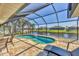 Gorgeous pool with screened enclosure and stunning water view creating a private retreat at 25 Medalist Ter, Rotonda West, FL 33947