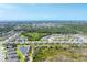 Panoramic aerial view of a peaceful neighborhood with well-manicured lawns and picturesque ponds at 284 Talquin Ct, Englewood, FL 34223