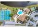 Aerial view of a community pool, tennis courts, and clubhouse, offering a vibrant and active lifestyle at 284 Talquin Ct, Englewood, FL 34223