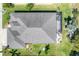 An aerial view shows the home's roof and screened-in patio, sitting on manicured green grass at 284 Talquin Ct, Englewood, FL 34223