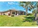Charming single-Gathering home featuring a spacious green lawn, and screened-in lanai at 284 Talquin Ct, Englewood, FL 34223