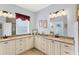 Well-lit bathroom with double sink vanity, granite counters, and glass shower at 284 Talquin Ct, Englewood, FL 34223