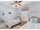 Cozy bedroom with two twin beds, wicker headboards, and coastal-themed decor at 284 Talquin Ct, Englewood, FL 34223