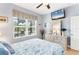 Bright bedroom with queen bed, TV, and a view of the green outdoor scenery at 284 Talquin Ct, Englewood, FL 34223