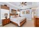 Comfortable bedroom featuring a tray ceiling and natural light at 284 Talquin Ct, Englewood, FL 34223