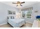 Relaxing bedroom with a queen bed, natural light, and coastal-themed bedding at 284 Talquin Ct, Englewood, FL 34223