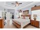 Bright bedroom with tray ceilings, neutral walls, and hardwood floors at 284 Talquin Ct, Englewood, FL 34223