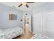 Comfortable bedroom with twin beds, closet, and view into the hallway at 284 Talquin Ct, Englewood, FL 34223